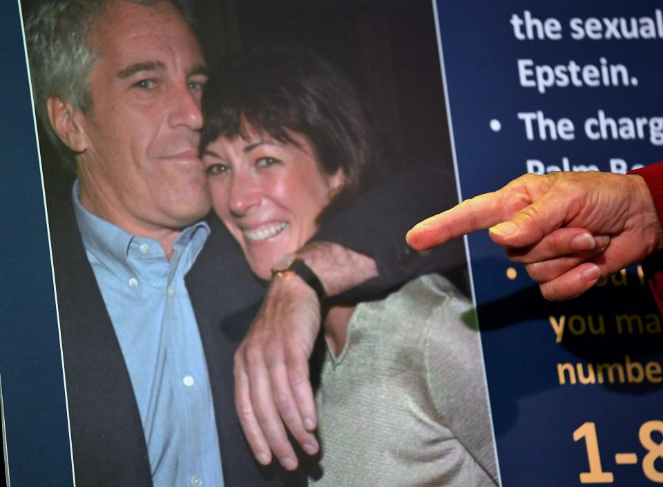A photo of Ghislaine Maxwell and Jeffrey Epstein is shown during a press conference held by US prosecutors in New York - AFP