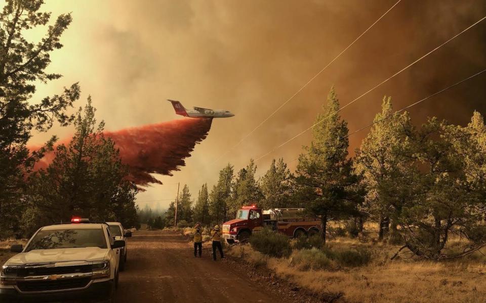 An aeroplane flies over the Grandview Fire as it rages in Jefferson and Deschutes Counties, in Oregon, US - Reuters