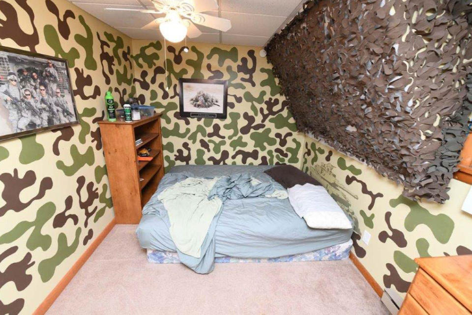 This image contained in Justice Department motion for continued pretrial detention of Jack Teixeira, shows his room at his father's home in North Dighton, Mass. A judge has put off a decision on whether the Massachusetts Air National guardsman accused of leaking highly classified military documents should be held in jail until his trial. Prosecutors said Teixeira kept an arsenal of weapons and said on social media that he would like to kill a "ton of people." (Justice Department via AP)