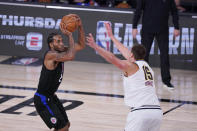 Los Angeles Clippers forward Kawhi Leonard (2) shoots over Denver Nuggets center Nikola Jokic (15) during the second half of an NBA conference semifinal playoff basketball game Tuesday, Sept. 15, 2020, in Lake Buena Vista, Fla. (AP Photo/Mark J. Terrill)