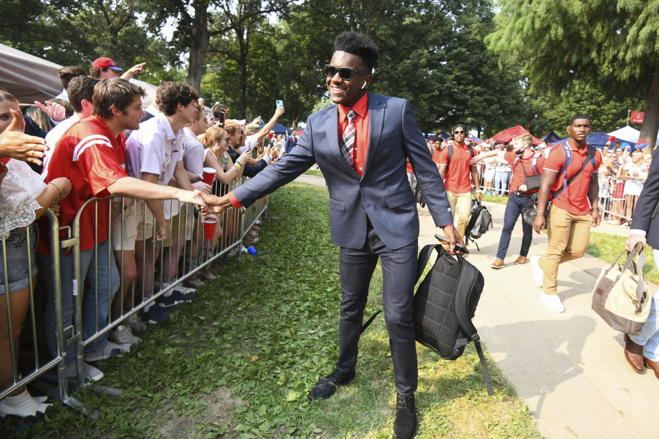 FILE - Mississippi defensive back MJ Daniels shakes hands with fans as the team walks through the Grove before an NCAA college football game against Austin Peay in Oxford, Miss., Saturday, Sept. 11, 2021. Marcus “MJ” Daniels Jr., a defensive back at Southern Mississippi, was shot to death Tuesday night, June 11, 2024, at an apartment complex in Hattiesburg, Miss., a coroner said. Daniels played his first two college seasons at Mississippi before transferring to Southern Miss in 2023. (AP Photo/Bruce Newman, File0