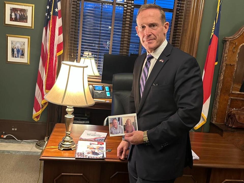 Sen. Ted Budd holds a photo of the Keith and Aviva Siegel, a couple, with ties to North Carolina, taken by Hamas during the Oct. 7 attack on Israel. Danielle Battaglia/Danielle Battaglia