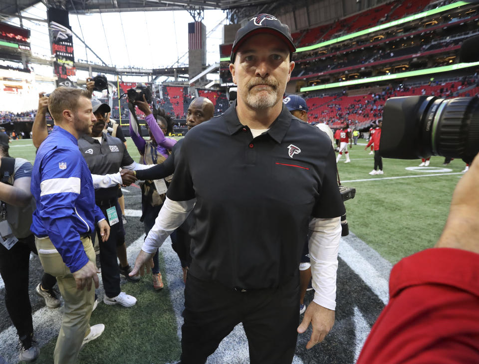 Atlanta Falcons head coach Dan Quinn, center, leaves the field after shaking hands with Los Angeles Rams head coach Sean McVay after an NFL football game Sunday, Oct. 20, 2019, in Atlanta. (Curtis Compton/Atlanta Journal-Constitution via AP)