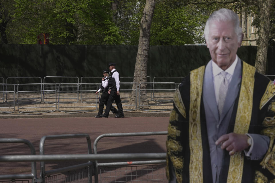 Police officers patrol besides a life-size cardboard of Britain's King Charles III in London, Wednesday, May 3, 2023. The Coronation of King Charles III will take place at Westminster Abbey on May 6. (AP Photo/Kin Cheung)