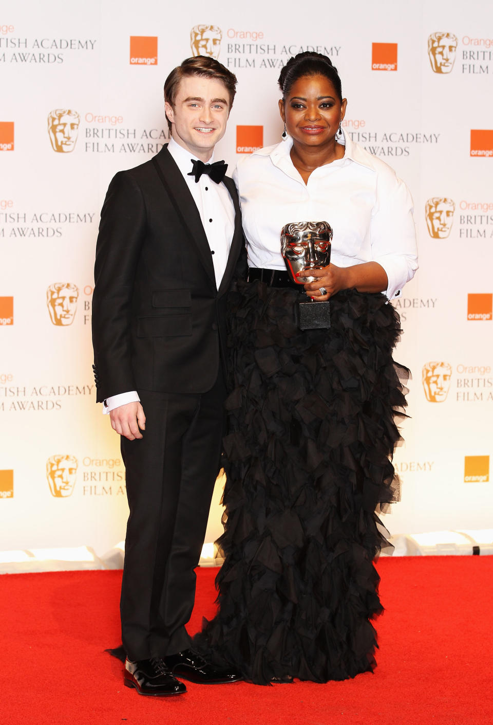 LONDON, ENGLAND - FEBRUARY 12: Best Supporting Actress winner Octavia Spencer poses in the press room with actor Daniel Radcliffe during the Orange British Academy Film Awards 2012 at the Royal Opera House on February 12, 2012 in London, England. (Photo by Chris Jackson/Getty Images)