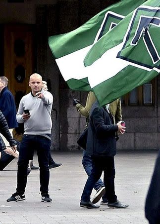 Jesse Torniainen (in gray shirt), a member of the Finnish neo-Nazi group Finnish Resistance Movement (FRM) is seen during FRM demonstration in front of the railway station in Helsinki, Finland, September 10, 2016. Picture taken September 10, 2016. Lehtikuva/via REUTERS