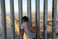 <p>In Tijuana, Mexico, a man looks through the U.S.-Mexico border fence into the United States on Sept. 25, 2016. The binational Friendship Park is one of the few places along the 2,000-mile border where separated families are allowed to meet. (Photo: John Moore/Getty Images) </p>