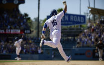 Los Angeles Dodgers' Will Smith (16) celebrates along with Russell Martin, back left, as he rounds first after hitting a two-run walkoff home run during the ninth inning of a baseball game against the Colorado Rockies, Sunday, June 23, 2019, in Los Angeles. (AP Photo/Mark J. Terrill)