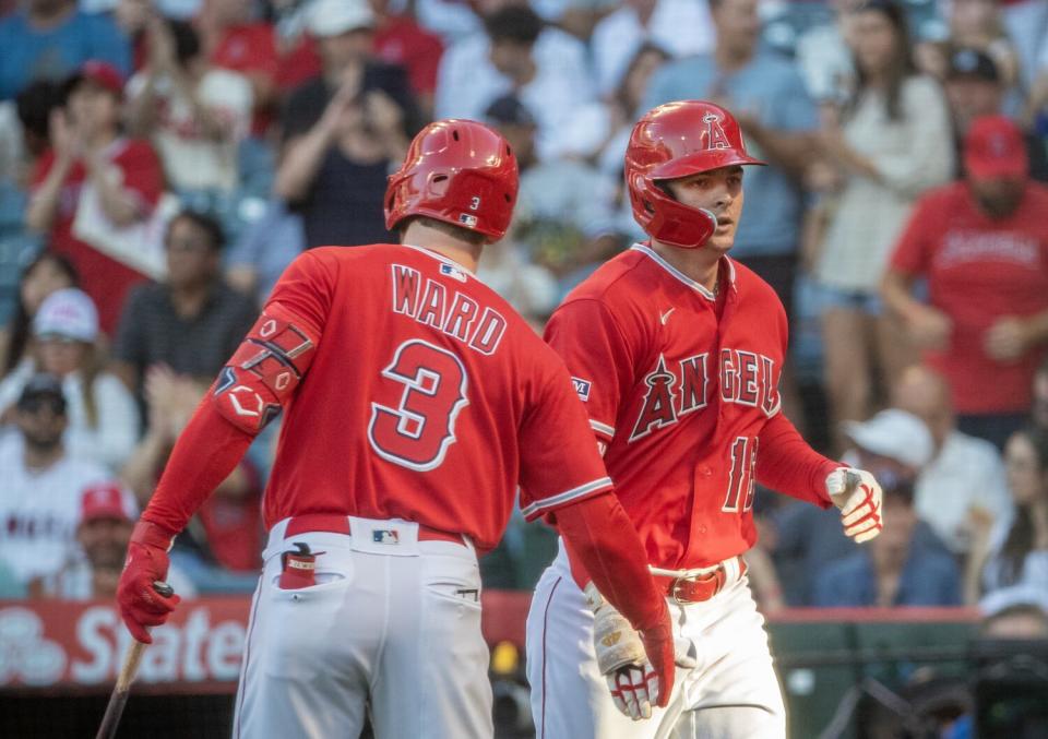 Taylor Ward congratulates Mickey Moniak after a home run for the Angels.