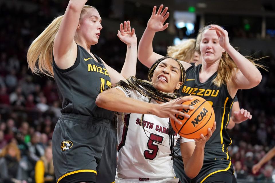 South Carolina forward Victaria Saxton (5) battles in the paint against Missouri guard Haley Troup, left, and Haley Frank, right, during the first half of an NCAA college basketball game, Sunday, Jan. 15, 2023, in Columbia, S.C. (AP Photo/Sean Rayford)