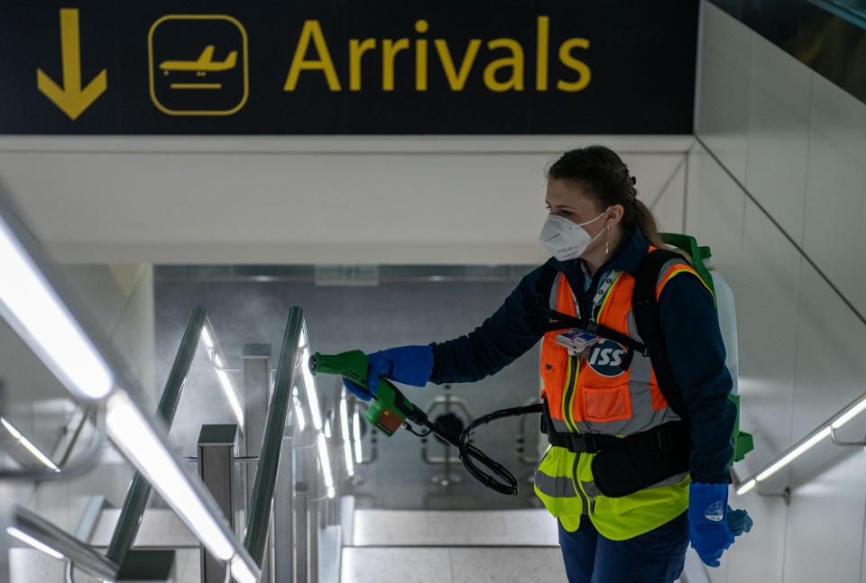 LONDON, ENGLAND - JUNE 09: Cleaners spray a peroxide based disinfectant on handrails and surfaces as a protective measure against the spread of the coronavirus (COVID-19) inside the currently closed North Terminal at Gatwick Airport on June 9, 2020 in London, England. Gatwick Airport has introduced a range of protective measures to battle the spread of the coronavirus (COVID-19) as the airport prepares to increase operating hours from June 15, 2020, and to resume operations at the North Terminal with a range of airlines. The airport’s North Terminal closed in March due to the impact that coronavirus outbreak had on the number of flights able to operate. (Photo by Chris J Ratcliffe/Getty Images)