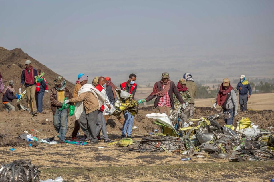 Rescuers work at the scene of an Ethiopian Airlines flight of a Boeing 737 Max 8 plane crash near Bishoftu, Ethiopia in March 2019 (Copyright 2019 The Associated Press. All rights reserved.)