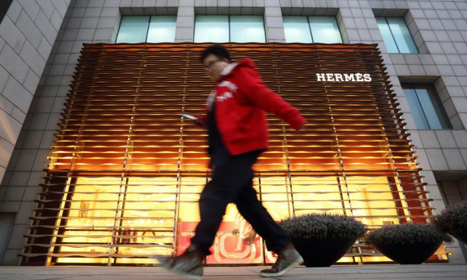 Man walks past Hermes shop