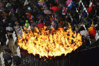 LONDON, ENGLAND - AUGUST 03: The Olympic Cauldron burns as spectators shelter from the rain on Day 7 of the London 2012 Olympic Games at Olympic Stadium on August 3, 2012 in London, England. (Photo by Ian Walton/Getty Images)