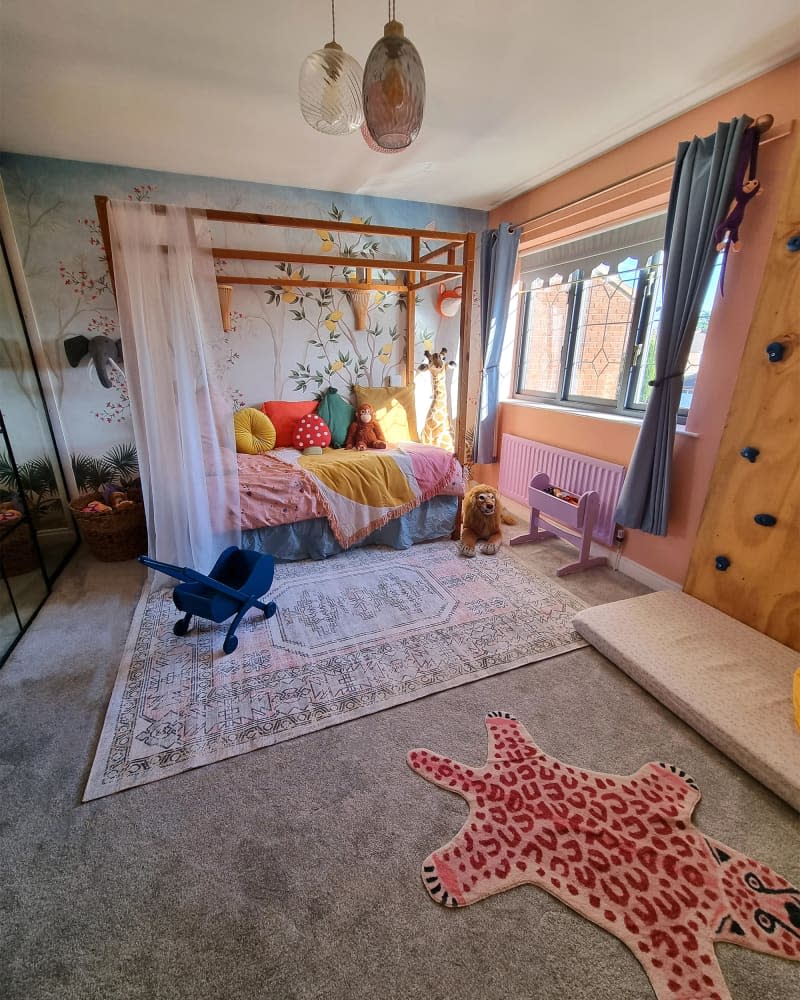 Four poster bed in colorful child's room.