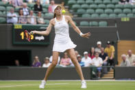 Kazakhstan's Elena Rybakina returns the ball to Australia's Ajla Tomljanovic during a women's singles quarterfinal match on day ten of the Wimbledon tennis championships in London, Wednesday, July 6, 2022. (AP Photo/Alberto Pezzali)