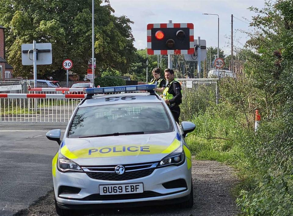 The scene where a police officer was left seriously injured after being hit by a train while trying to save a distressed man on the railway lines. (SWNS)