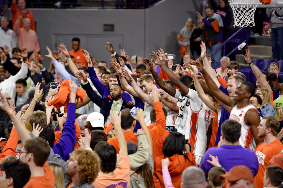 Clemson fans and players celebrate after an NCAA college basketball game against Florida State Saturday, Feb. 29, 2020, in Clemson, S.C. Clemson won 70-69. (AP Photo/Richard Shiro)