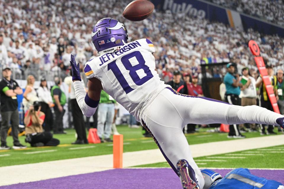 Minnesota Vikings receiver Justin Jefferson catches a touchdown pass as Detroit Lions cornerback Cameron Sutton defends during the second quarter at U.S. Bank Stadium in Minneapolis on Sunday, Dec. 24, 2023.