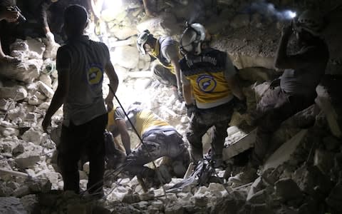 Civil defense members carry out search and rescue works after the airstrikes in Idlib province - Credit: Anadolu