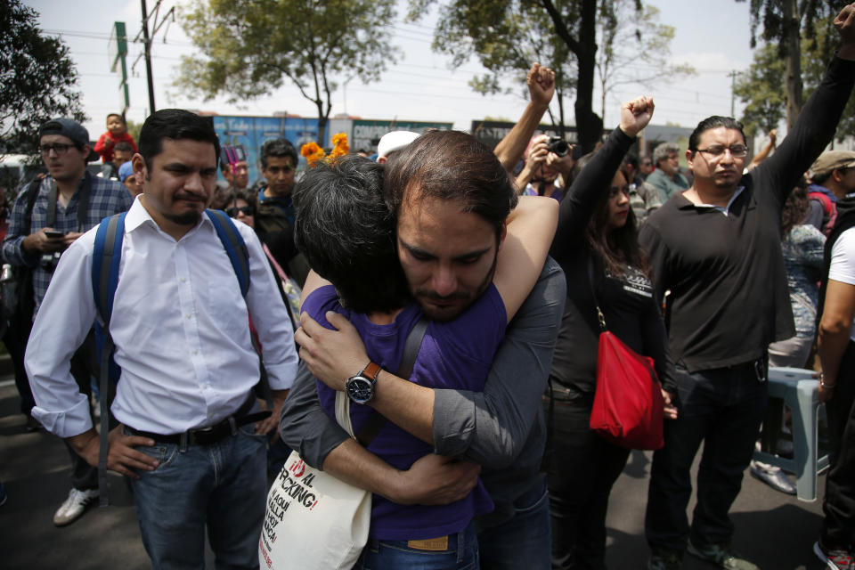 A couple embraces during the one year anniversary of the 7.1 Mexico City earthquake, at the Multifamiliar de Tlalpan, Wednesday, Sept. 19, 2018. The building collapsed one year ago during the earthquake that struck the city leaving scores dead, injured and homeless. (AP Photo/Eduardo Verdugo)