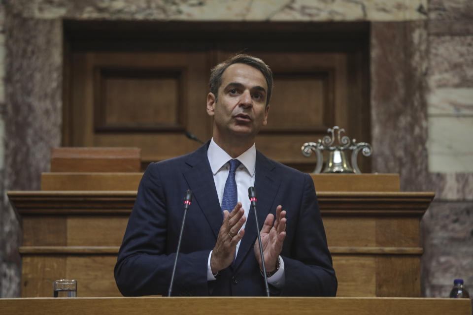 Greece's Prime Minister Kyriakos Mitsotakis, addresses lawmakers inside the parliament, in Athens, on Friday, July 19, 2019. Prime Minister Kyriakos Mitsotakis' conservative New Democracy party returned to power after winning a general election earlier this month on a pledge to cut taxes imposed during Greece's three successive international bailouts. (AP Photo/Petros Giannakouris)