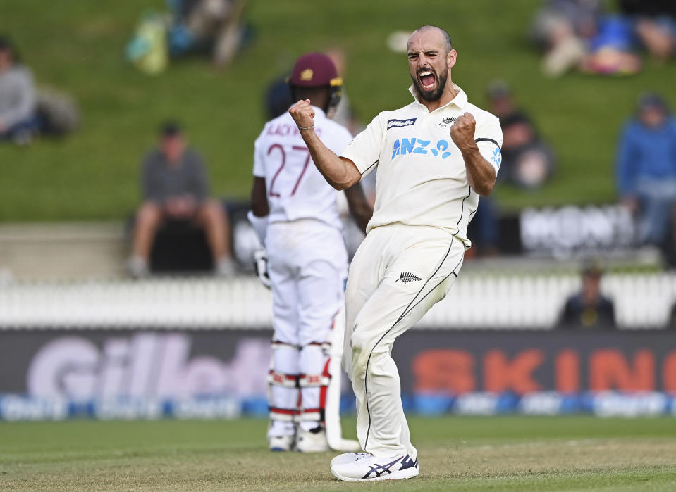 New Zealand's Daryl Mitchell celebrates the wicket of the West Indies' Jason Holder during play on day three of their first cricket test in Hamilton, New Zealand, Saturday, Dec. 5, 2020. (Andrew Cornaga/Photosport via AP)