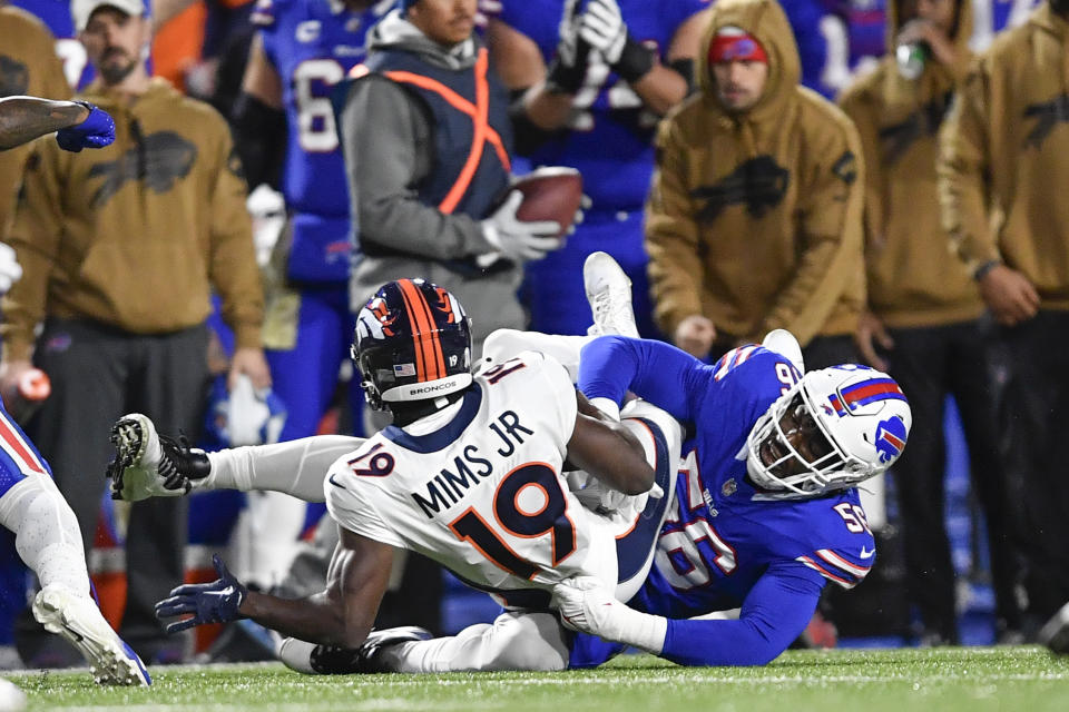 Buffalo Bills' Leonard Floyd, right, tackles Denver Broncos' Marvin Mims Jr. (19) during the first half of an NFL football game, Monday, Nov. 13, 2023, in Orchard Park, N.Y. (AP Photo/Adrian Kraus)