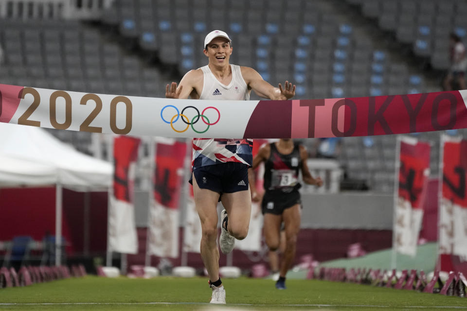 Joseph Choong of Britain crosses the finish line to win the men's modern pentathlon at the 2020 Summer Olympics, Saturday, Aug. 7, 2021, in Tokyo, Japan. (AP Photo/Hassan Ammar)