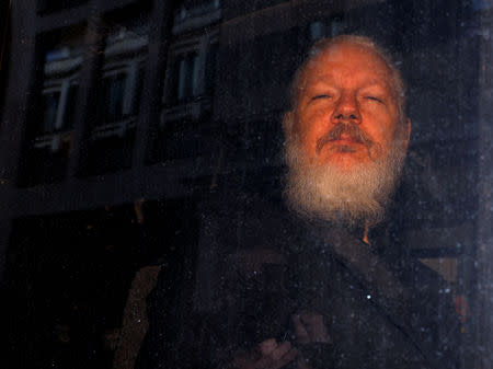 FILE PHOTO: WikiLeaks founder Julian Assange is seen as he leaves a police station in London, Britain April 11, 2019. REUTERS/Peter Nicholls/File Photo