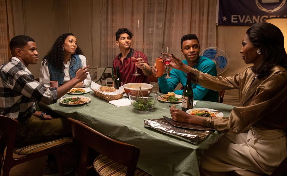 People sitting around a dining table and toasting