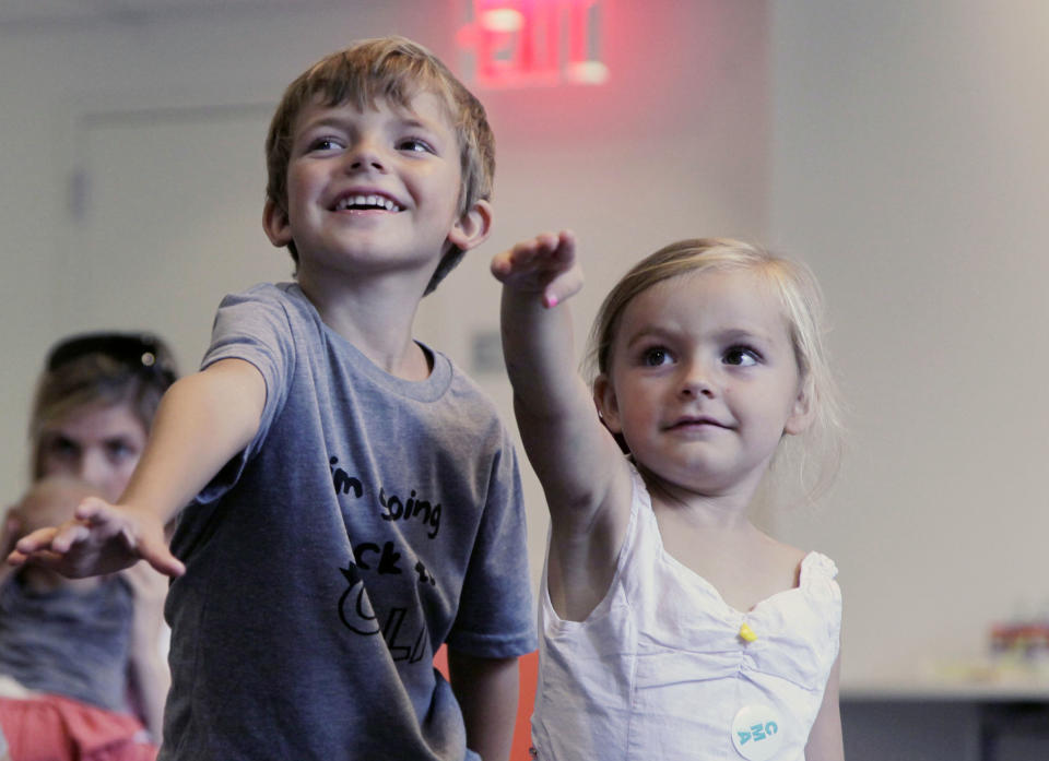 In this Sept. 5, 2012, photo, from left, Aidan Lain, 7, and Zoe Shyba, 3, play "Kinect Sesame Street TV" at the Sesame Street Workshop in New York. "Kinect Sesame Street TV", launching Tuesday, Sept. 18, 2012, uses Kinect, a motion and voice-sensing controller created by Microsoft, to give Elmo, Big Bird and the rest of the Sesame Street crew a chance to have a real two-way conversation with their pint-sized audience. The effort represents the next step in the evolution of television, adding an interactive element to what's still largely a passive, lean-back experience. (AP Photo/Mark Lennihan)