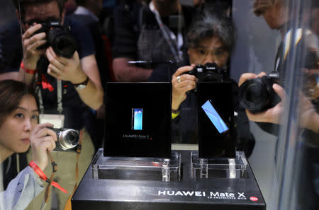 People take pictures of the new Mate X smartphone, ahead of the Mobile World Congress (MWC 19) in Barcelona, Spain, February 24, 2019. REUTERS/Sergio Perez