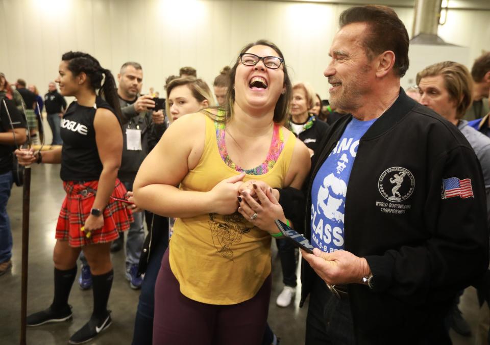 Arnold Schwarzenegger fist-bumps Highland Games athlete Emily Adams during a previous tour of his Arnold Sports Festival. After two years of scaling back or cancellations due to the pandemic, the Arnold returns in full force Thursday through Sunday.