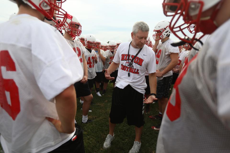 Hilton High School football coach, Rich Lipani, goes over practice expectations during the first day of official practice.