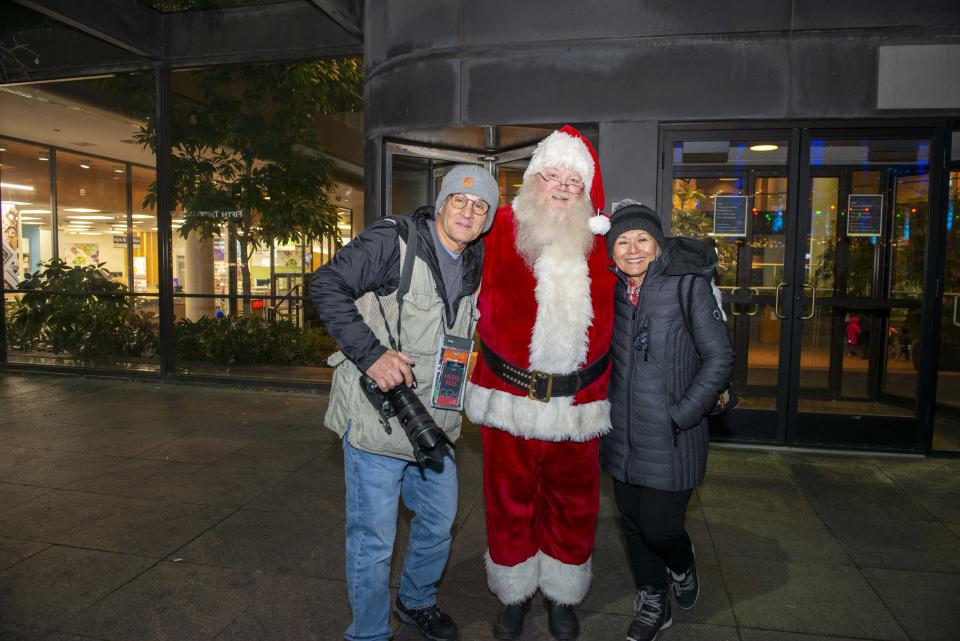 Macy's Light Up the Square, the time-honored holiday tradition took place on Friday, Nov. 26, 2021 at Fountain Square. The event featured lighting up the Christmas Tree, live music, ice skating, fireworks and an appearance from Santa Claus. Joe Simon and Catalina Landivar Simon with Santa in front of the Weston.