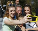 United Kingdom Indenpence Party leader Nigel Farage poses for a selfie with some girls during an election campaign event in Dudley, central England, April 7, 2015. REUTERS/Darren Staples TPX IMAGES OF THE DAY