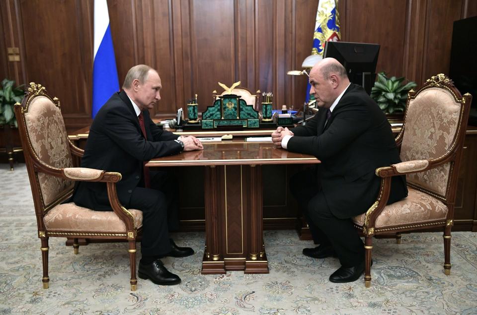 Russian President Vladimir Putin, left, listens to Tax Service chief Mikhail Mishustin during their meeting in the Kremlin in Moscow, Russia, Wednesday, Jan. 15, 2020. Putin has named Tax Service chief Mikhail Mishustin as Russia's new prime minister Wednesday Jan. 15. The 53-year-old Mishustin has worked in the government since 1998, keeping a low profile while serving as the head of the Federal Tax Service since 2010. (Alexei Nikolsky, Sputnik, Kremlin Pool Photo via AP)