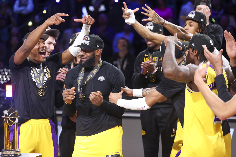 Los Angeles Lakers forward Rui Hachimura, left, celebrates with forward LeBron James after James was named NBA In-Season Tournament MVP, after the Lakers defeated the Indiana Pacers 123-109 in the championship game in the NBA basketball In-Season Tournament on Saturday, Dec. 9, 2023, in Las Vegas.(AP Photo/Ian Maule)