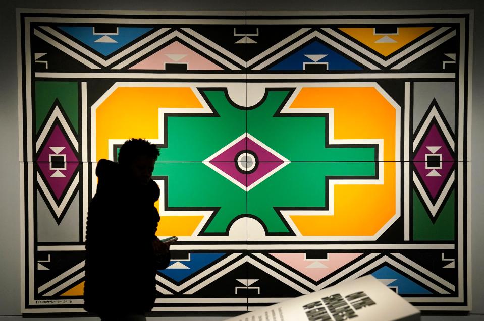 A person walks past Esther Mahlangu "Ndebele Abstract" during a press preview of the exhibition "Giants: Art from the Dean Collection" of Swizz Beatz and Alicia Keys at the Brooklyn Museum in New York on February 6, 2024.