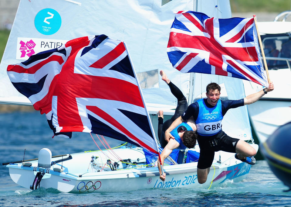 WEYMOUTH, ENGLAND - AUGUST 10: Luke Patience (L) and Stuart Bithell (R) of Great Britain celebrate finishing second and winning the silver medal in the Men's 470 Sailing on Day 14 of the London 2012 Olympic Games at the Weymouth & Portland Venue at Weymouth Harbour on August 10, 2012 in Weymouth, England. (Photo by Laurence Griffiths/Getty Images)
