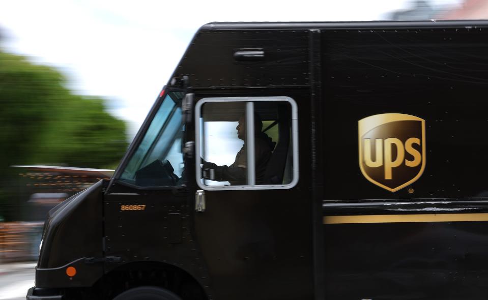 A UPS delivery truck drives through in intersection on June 12, 2023 in San Francisco, California.