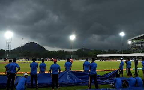 Groundstaff wait to cover the field as dark skies approach during the 2nd One Day International match between Sri Lanka and England at Rangiri Dambulla International Stadium - Credit:  Gareth Copley/Getty Images