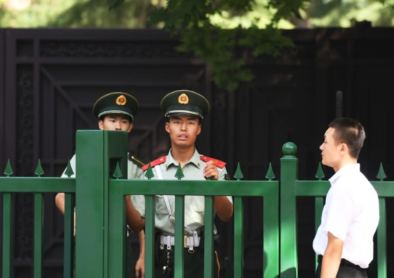 Chinese paramilitary policemen stand outside the entrance to the North Korean embassy in Beijing on September 9, 2016