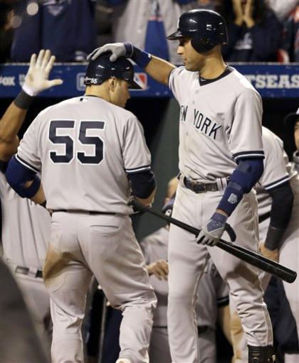 Derek Jeter congratulates Russell Martin after Martin hit a solo HR Sunday against the Orioles. (AP) 