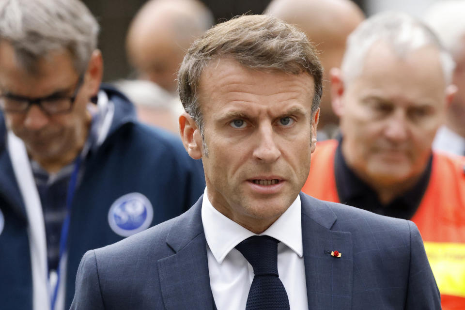 French President Emmanuel Macron talks to the press at the Gambetta high school in Arras, northeastern France, Friday Oct. 13, 2023. A man of Chechen origin who was under surveillance by the French security services stabbed a teacher to death at his former high school and critically wounded two other people in northern France on Friday, authorities said. (Ludovic Marin, Pool via AP)