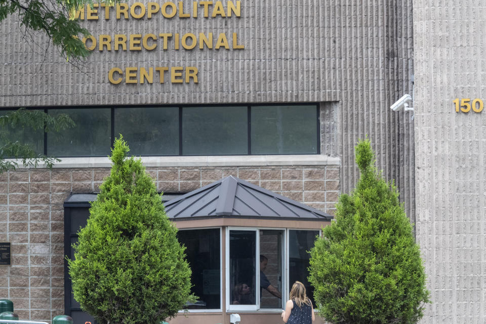 An employee checks a visitor outside the Metropolitan Correctional Center, Tuesday, Aug. 13, 2019 in New York. The warden at the federal jail where Jeffrey Epstein took his own life over the weekend was removed Tuesday and two guards who were supposed to be watching the financier were placed on leave while federal authorities investigate the death. The move by the Justice Department came amid mounting evidence that the chronically understaffed Metropolitan Correctional Center may have bungled its responsibility to keep the 66-year-old Epstein from harming himself while he awaited trial on charges of sexually abusing teenage girls. (AP Photo/Mary Altaffer)