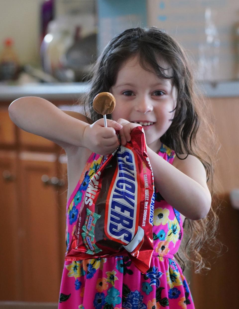 A young girl celebrates after receiving a food delivery during a mandatory quarantine for coronavirus near Avon, Colorado, on March 26, 2020.