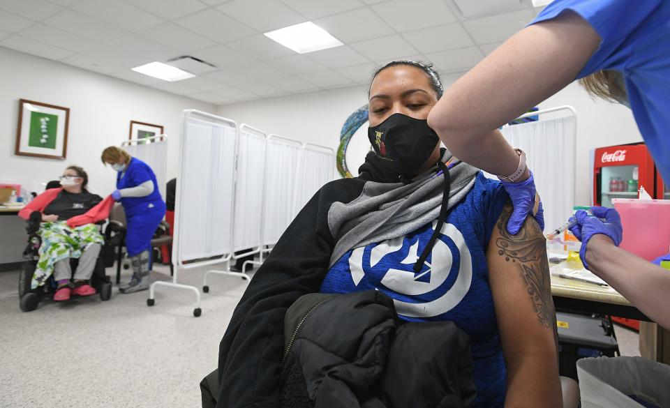 Janae Andrews receives a COVID-19 vaccination from Gloria Hennessy, R.N., 53, at the LECOM Center for Health & Aging, 3910 Schaper Ave., in January 2021. The center will provide the new COVID-19 vaccines later this month.