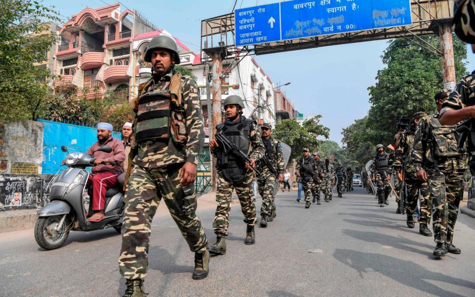 Security personnel patrol on a street following clashes in New Delhi - AFP
